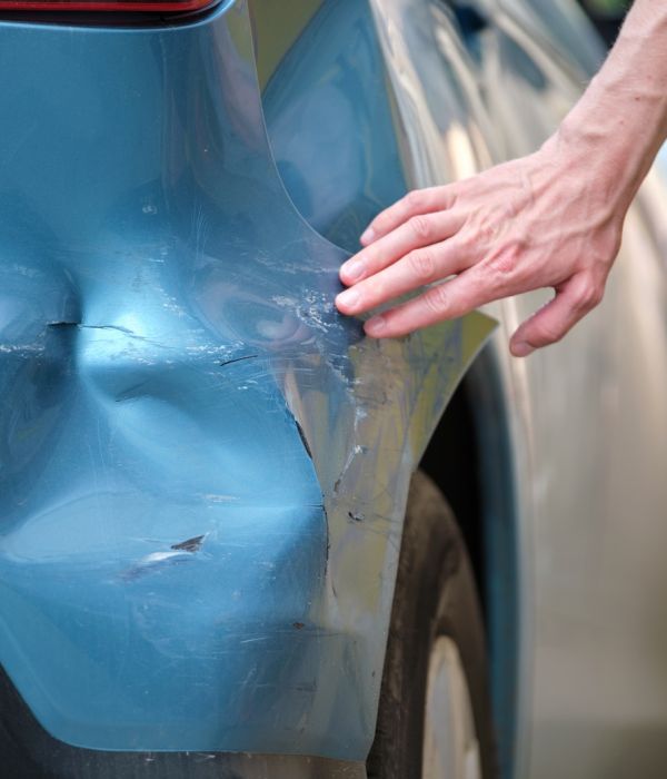 Car Dent Repair Service Inspecting Damage On Blue Vehicle