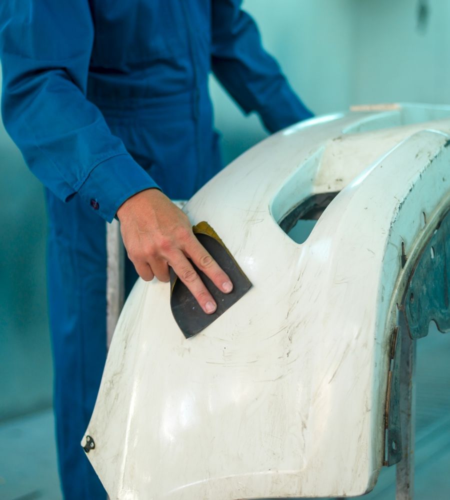 Dent Removal Service Expert Working On Car Body Repair Panel