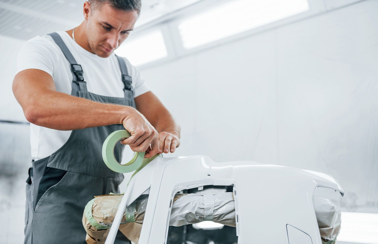 Auto Painting Service Professional Applying Masking Tape