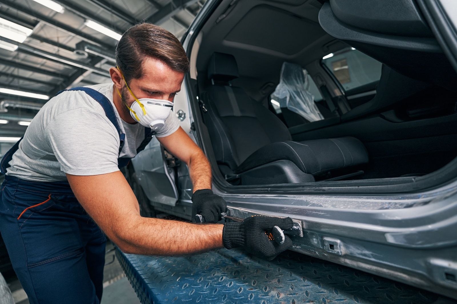 Auto Frame Repair Service Technician Working On Vehicle Repair