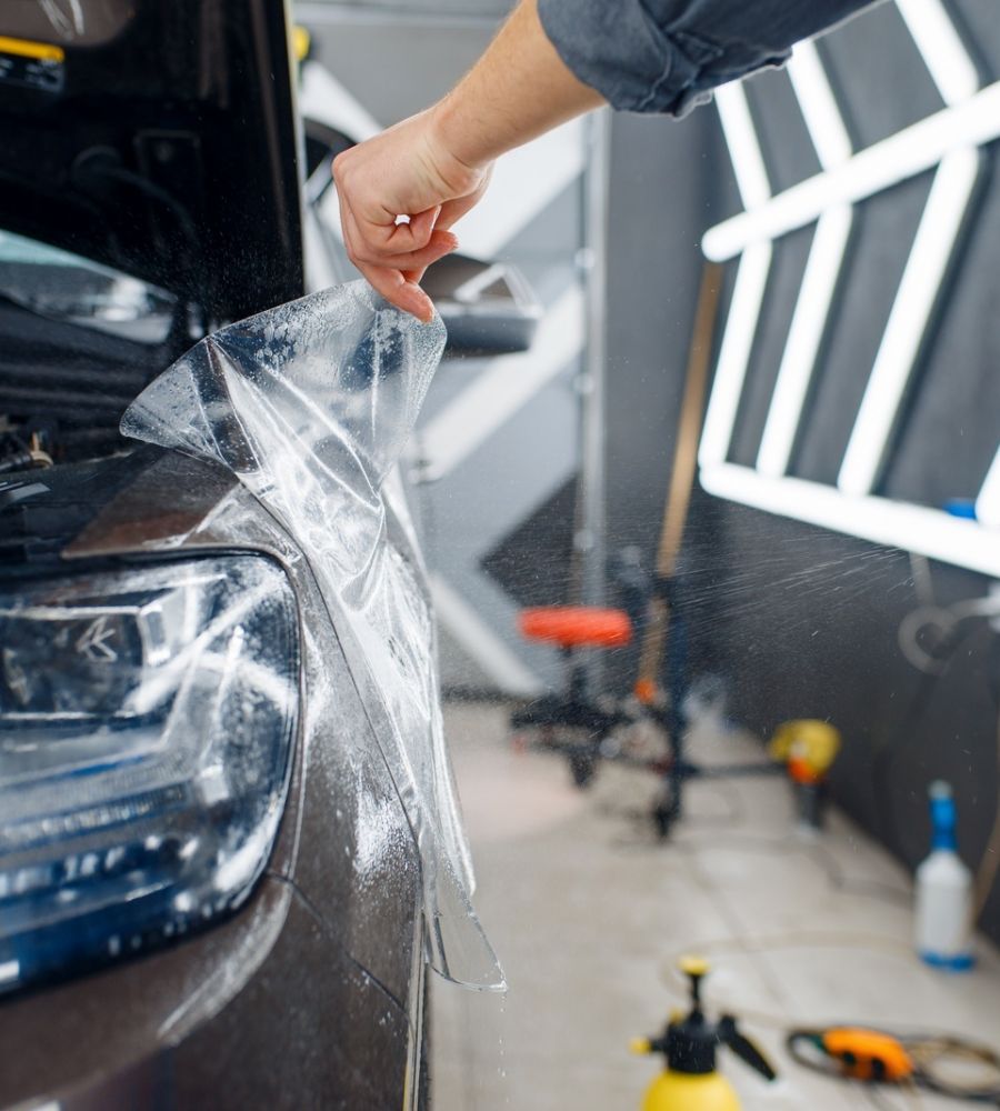 Applying Ppf Film To Car Fender With Spraying Water
