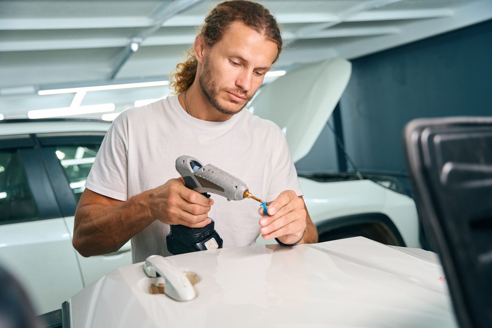 Car Dent Removal Service Technician Working With Tools In Shop