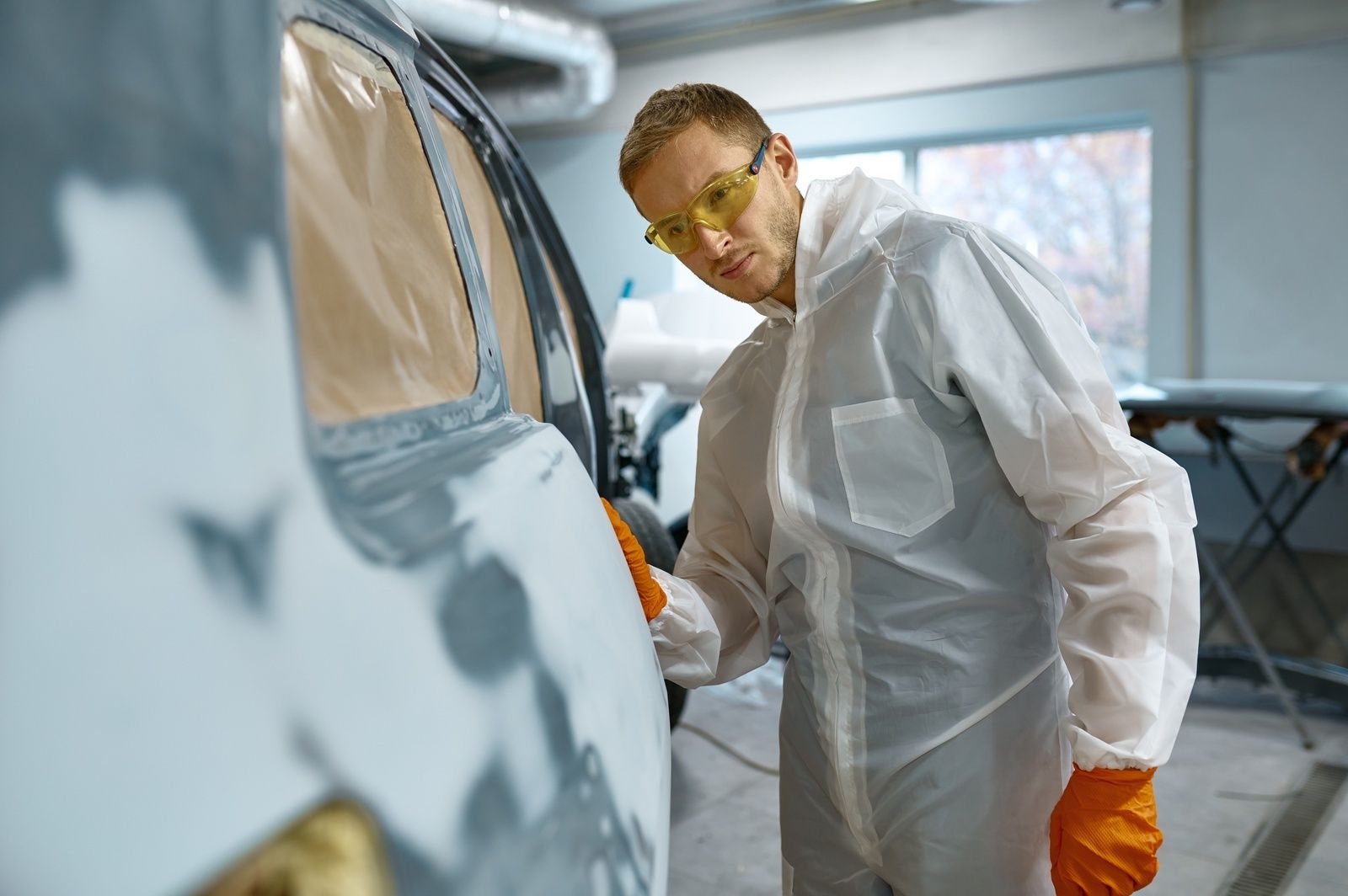 Autobody Repair Technician Preparing Car For Painting