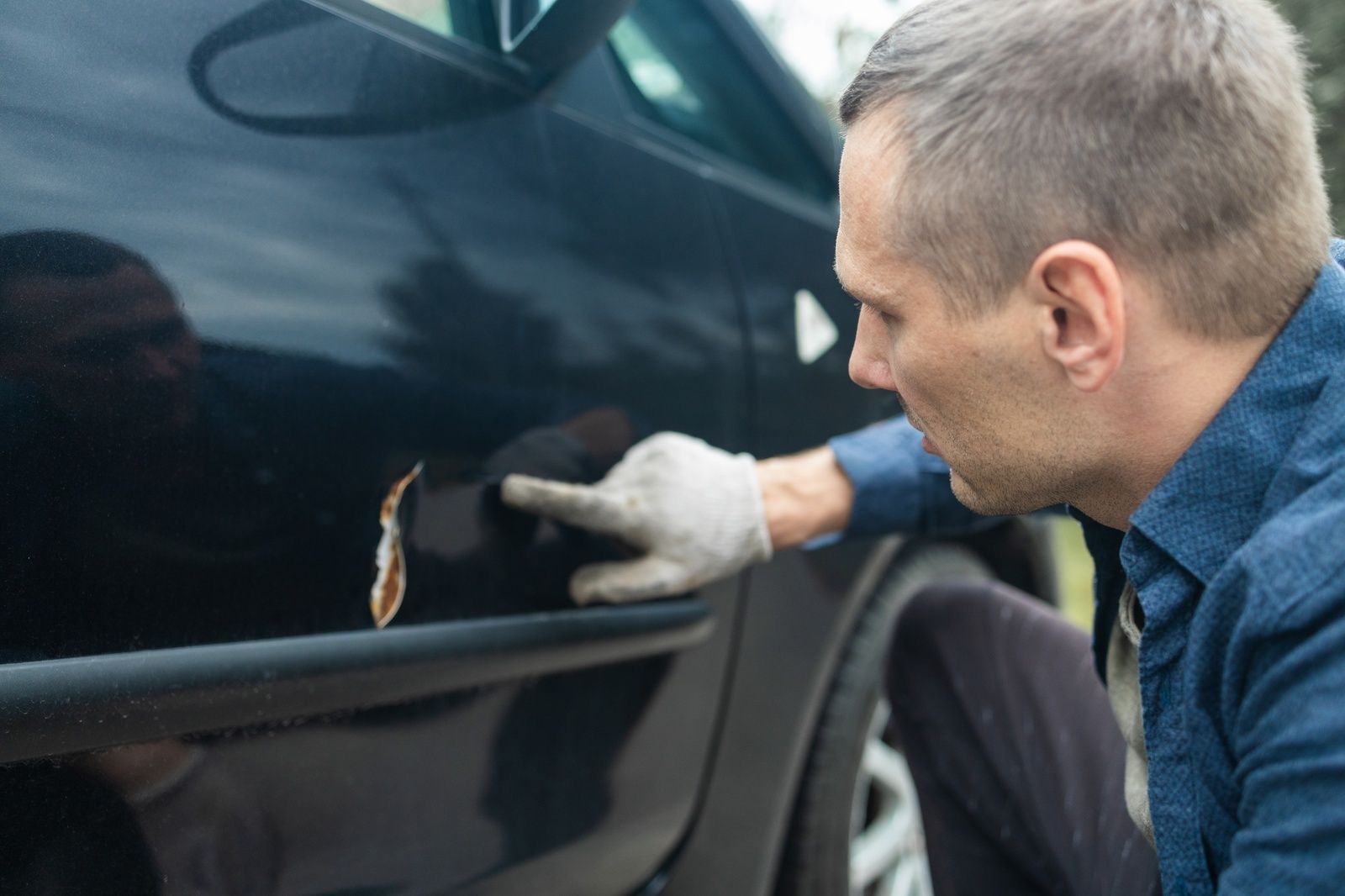 Car Autobody Repair Technician Assessing Damage Vehicle Door